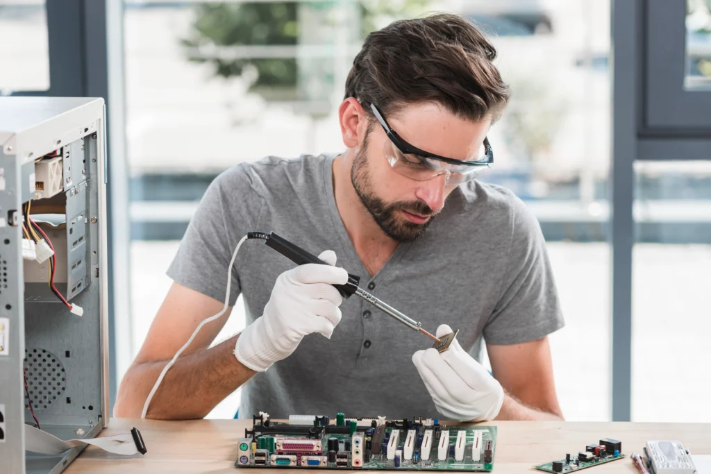young male technician working computer ram