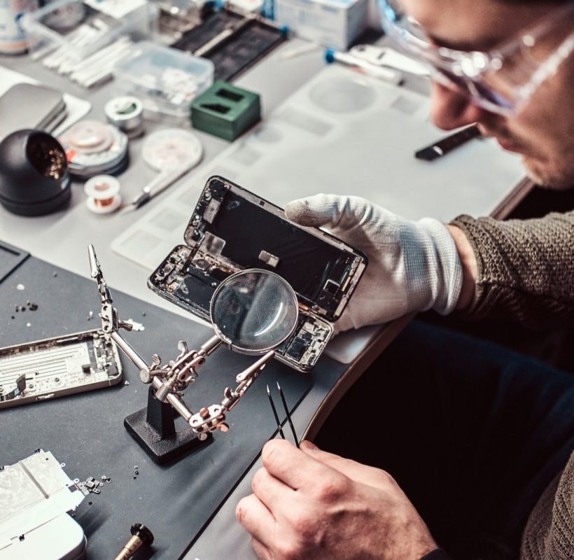 electronic-technician-repair-damaged-smartphone-in-the-workshop-1.jpg